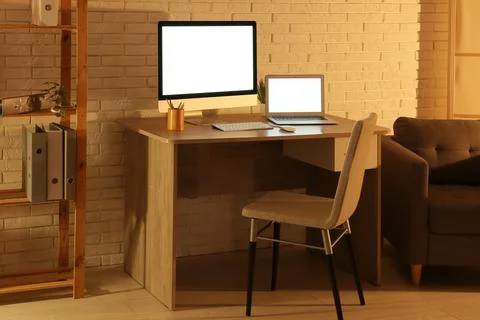 Modern programmers workplace with computer monitor, laptop and shelving unit  Stock-Fotos