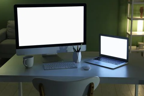 Modern programmer's workplace with computer monitor, laptop and cup of tea in Stock-Fotos