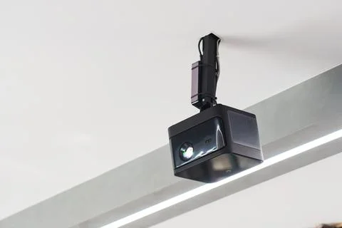 Modern projector mounted on ceiling in a contemporary office space 库存照片
