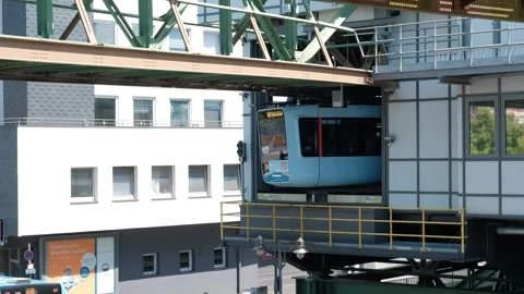 Modern public suspension train entering an elevated station building with a.. Vídeo Stock 337292392