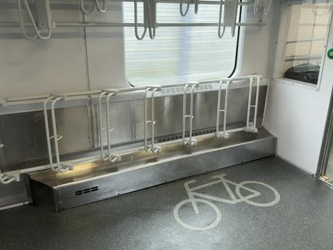 Modern public transport interior featuring dedicated bicycle rack system an.. Stock Photos