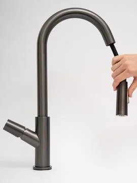 Modern pull-down kitchen faucet on white background Stock Photos