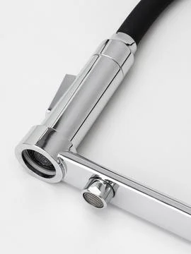 Modern pull-down kitchen faucet on white background 写真素材
