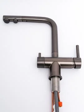 Modern pull-down kitchen faucet on white background Fotos de archivo