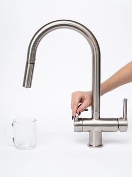 Modern pull-down kitchen faucet on white background Fotos de archivo