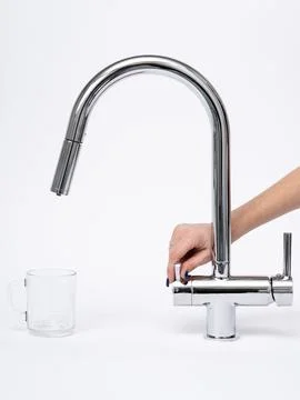 Modern pull-down kitchen faucet on white background Fotos de archivo
