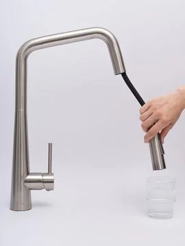 Modern pull-down kitchen faucet on white background Fotos Stock
