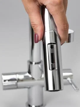 Modern pull-down kitchen faucet on white background 写真素材