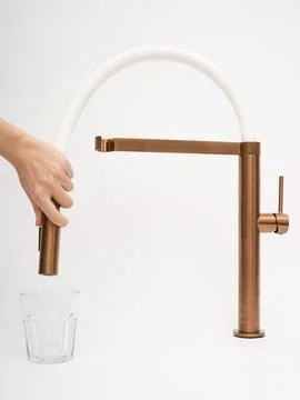 Modern pull-down kitchen faucet on white background 写真素材