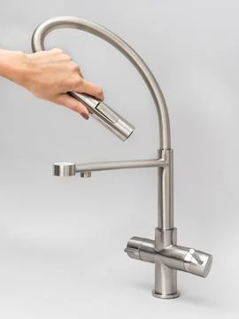 Modern pull-down kitchen faucet on white background 写真素材