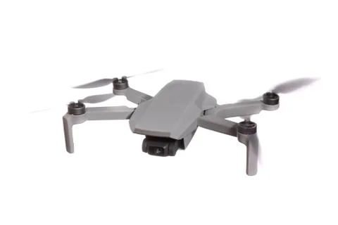 Modern quadcopter drone with a camera flying in the air. Isolated on white ba Stock Photos