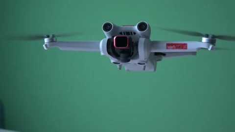 Modern quadcopter drone hovering with glowing green lights 库存影片 329223034