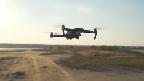 Modern quadrocopter flying near pilot middle shot slow motion Stock Footage 75542644