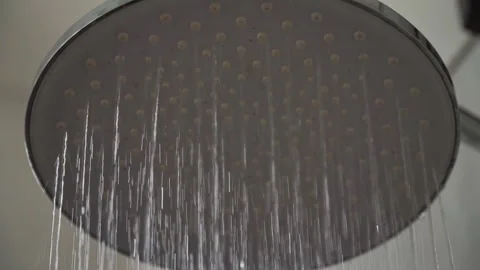 Modern rainfall shower head releasing clean water with a steady stream in a Stock Footage 342637562