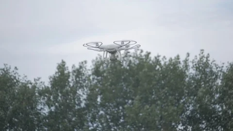 Modern RC UAV Drone quadcopter with camera flying in sky Stock Footage 94368135