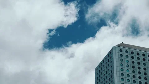 A modern rectangular building with circular windows arranged in a grid pattern Stock Footage 338165225