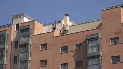 Modern red brick apartment building facade tilting up Stock-Footage 329934929