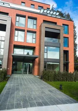 Modern Red Brick Apartment Complex with solid rock fence wall. Home residenti Stock Photos