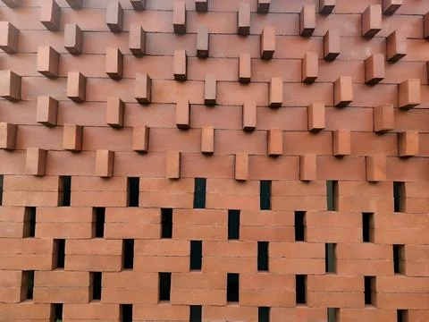 Modern red brick wall texture with a unique geometric pattern Stock Photos