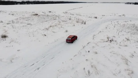 Modern red car driving and drifting on a snowy road Stock Footage 78625977