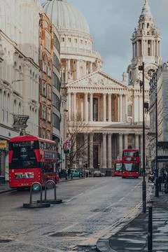 Modern red double decker buses on a street in City of London, UK, St. Paul's  Foto stock