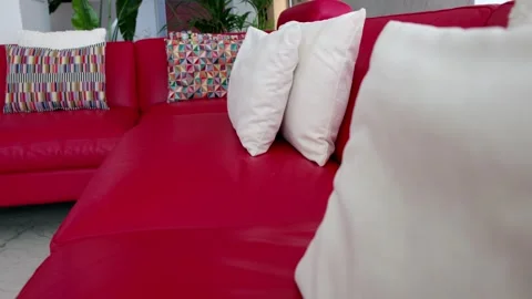 Modern Red Leather Sofa with Decorative Pillows Stock Footage 333832565