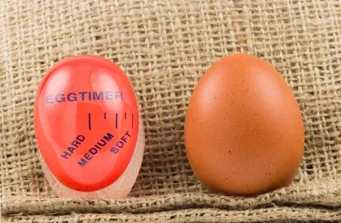 Modern red, plastic kitchen timer with egg Stock Photos