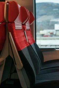 Modern Red Train Seats with Window View in Clean European Railway Car Stock Photos