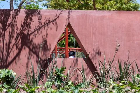 Modern red wall, triangular opening in renovated Guadalajara Revolution Park 库存照片