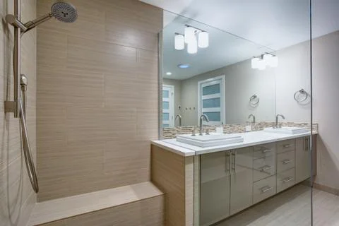 Modern refreshing bathroom features a Walk-in shower with beige subway tiled  Stock Photos