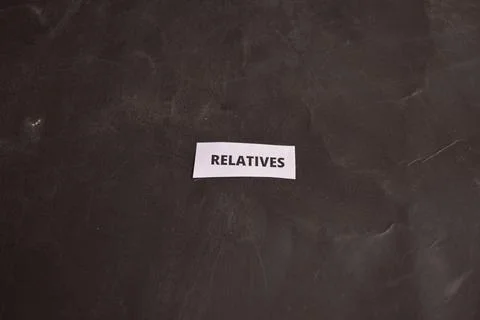Modern Relatives typography message card with copy space on dark backdrop Fotos Stock