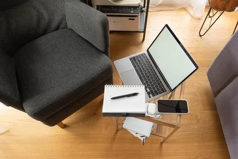 Modern remote workspace with a computer laptop mockup on a small table Stock Photos