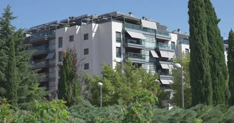 Modern residential apartment complex surrounded by landscaped greenery Stock-Footage 336582418