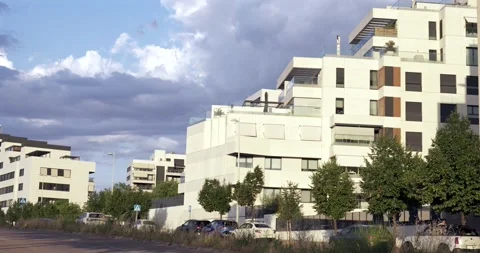 Modern residential apartment complex under dramatic clouds Stock Footage 337121073