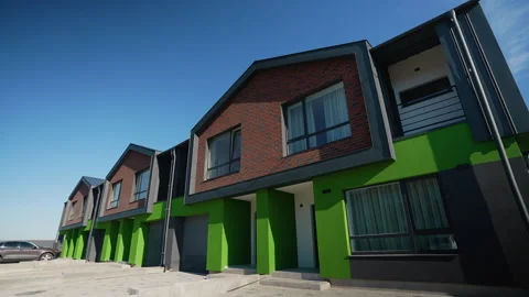 A modern residential area featuring elegant townhouses with brick facades and Video stock 297301243