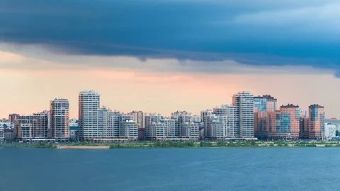 Modern residential building on the banks of the river at sunset. Timelapse Stock Footage