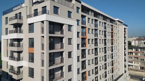 Modern residential building facade with grey panels, balconies and blue sky Stock Footage 346233522