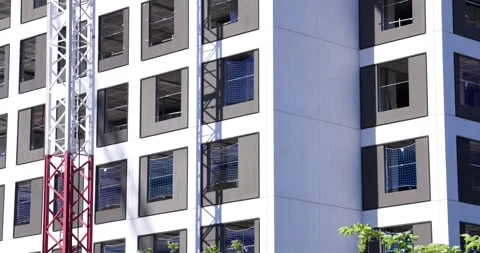 Modern residential building facade under construction with tower crane Stock-Footage 336301137