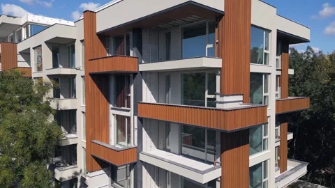 Modern Residential Building Under Construction with Yellow Tower Crane and Sky Stock Footage 346698104