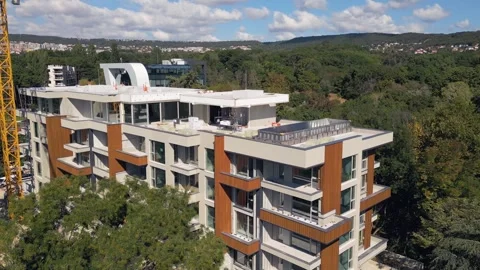 Modern Residential Building Under Construction with Yellow Tower Crane and Sky Stock Footage 346698961