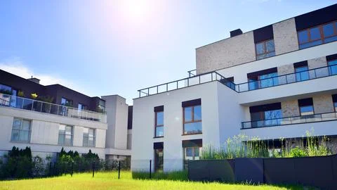 A modern residential building in the vicinity of trees. Stock Photos