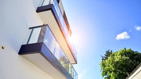 A modern residential building in the vicinity of trees. Stock Photos