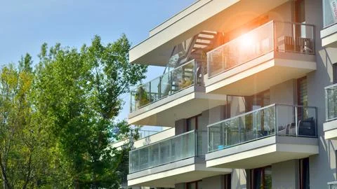 A modern residential building in the vicinity of trees. Stock Photos