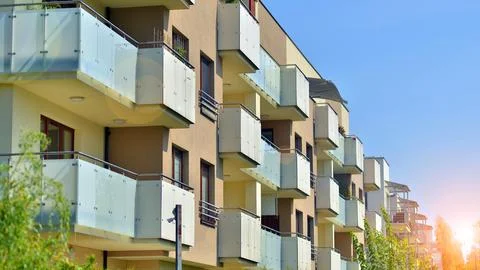 A modern residential building in the vicinity of trees. Stock Photos