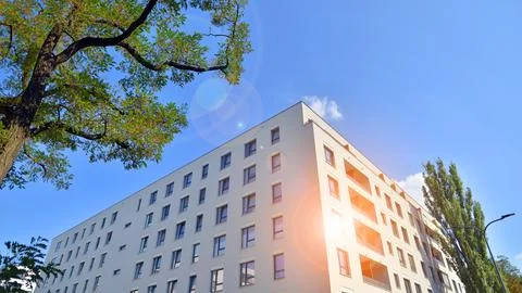 A modern residential building in the vicinity of trees. Stock Photos