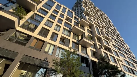 Modern residential complex with two sections and stylobate showing underground Stock Footage 314852978