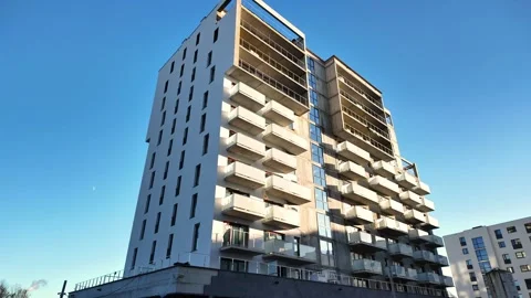 Modern Residential Tower Facade | Vertical Pan Up | Urban Architecture 4K Stock Footage 325446482