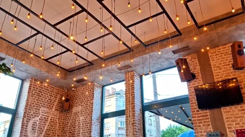 Modern Restaurant Ceiling with Warm Hanging Lights and Brick Walls Stock-Footage 338426584