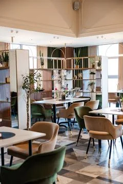 Modern restaurant interior with arched windows and marble patterned floor Stock Photos