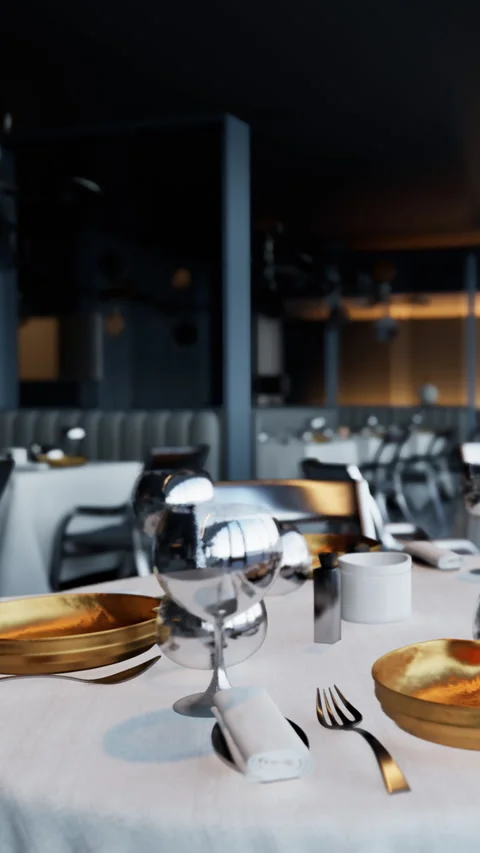 A modern restaurant shows a dining table set with shiny glasses and gold plates Stock-Footage 337944610